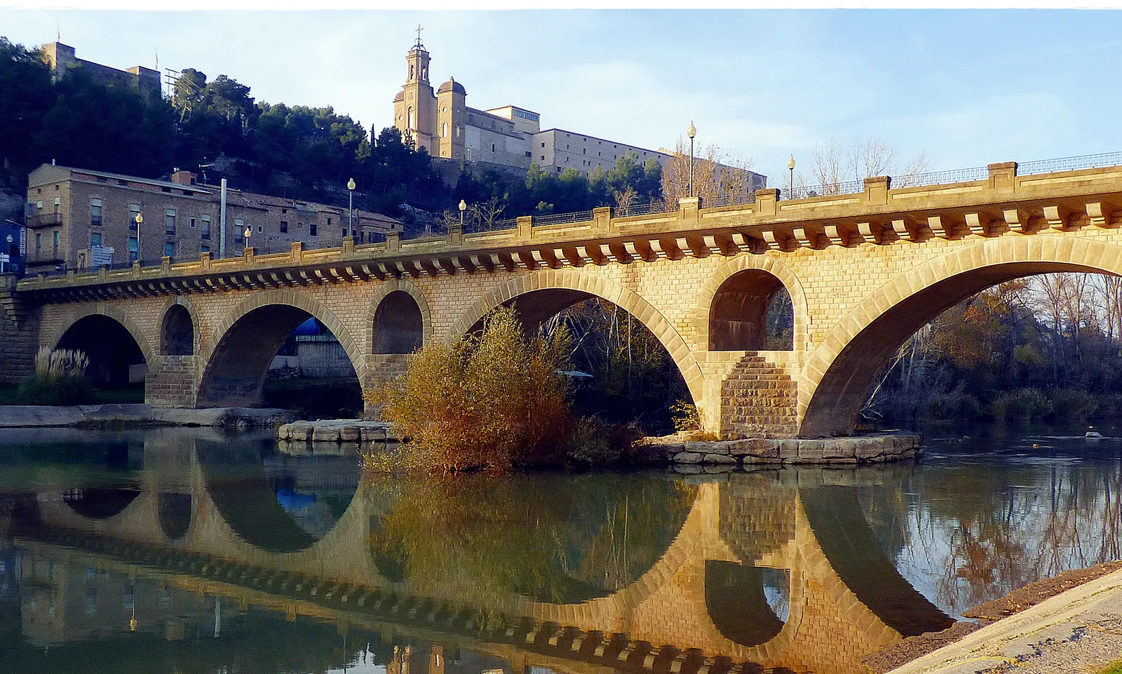 The bridge at Balaguer reflected in the Segre, with the Sant Crist sanctuary on the hill
