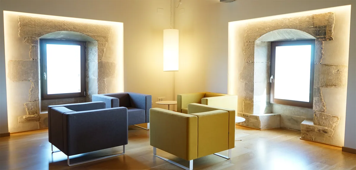 The lounge at Hotel Santuari with the original stone windows